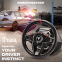 Zwart racestuur met rode markering, in een garage-achtige setting met een auto op de achtergrond. Tekst 'AWAKEN YOUR DRIVER INSTINCT' en 'T128'.