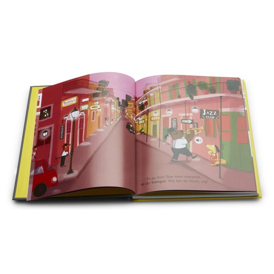 Een geopend kinderboek met een illustratie van een straat in New Orleans. Een hond speelt trompet bij een jazzclub.