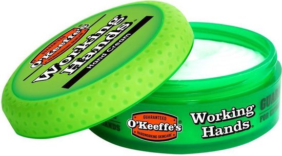 Open groene pot O'Keeffe's Working Hands Hand Cream, deksel ernaast, met witte crème.