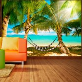 Fotobehangkoning - Behang - Vliesbehang - Fotobehang Tropisch Paradijs - Palmbomen - Strand - Zee - 150 x 105 cm