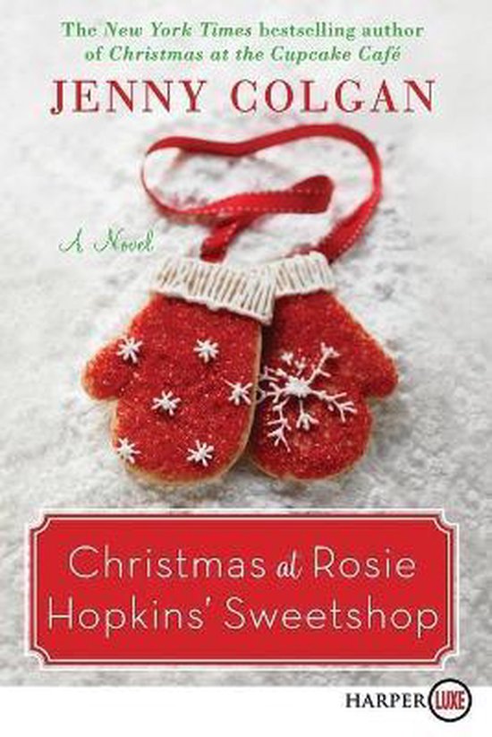 Couverture du livre "Christmas at Rosie Hopkins' Sweetshop" par Jenny Colgan. Deux moufles de Noël en forme de biscuits, décorées de paillettes et de flocons de neige, reposent sur un fond blanc.