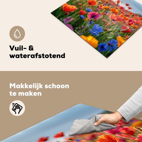 Een hand die een kookplaatbeschermer met bloemenprint schoonmaakt, vuil- en waterafstotend.