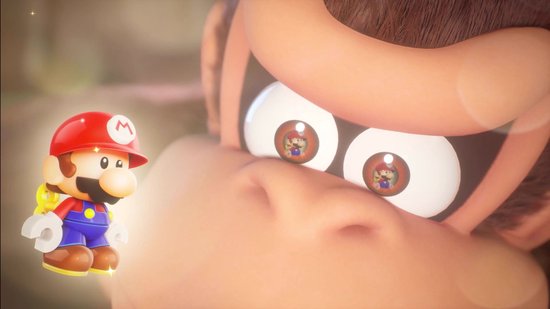 Een kleine, glimmende Mario kijkt op naar de grote ogen van Donkey Kong met Mario's weerspiegeld.