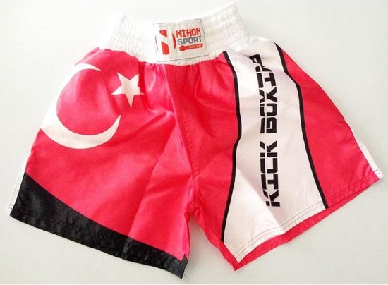 Rode kickboksbroek met witte tailleband, Turkse vlagprint, 'Kick Boxing' op de zijkant en zwarte en witte accenten.
