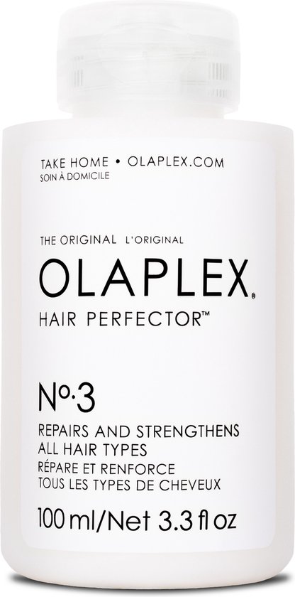 Witte fles Olaplex Hair Perfector No.3 met een fliptopdop. Tekst op de fles: 'TAKE HOME OLAPLEX.COM THE ORIGINAL L'ORIGINAL OLAPLEX HAIR PERFECTOR N°.3 REPAIRS AND STRENGTHENS ALL HAIR TYPES RÉPARE ET RENFORCE TOUS LES TYPES DE CHEVEUX'.