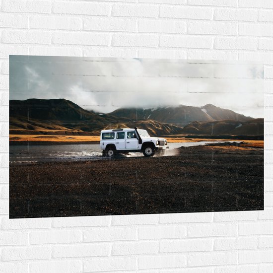 WallClassics - Muursticker - Witte Grote Auto door het Water bij het Berglandschap - 120x80 cm Foto op Muursticker