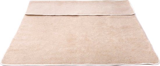 Beige lamswollen deken, plat uitgevouwen met een vouw in het midden, met witte bies.