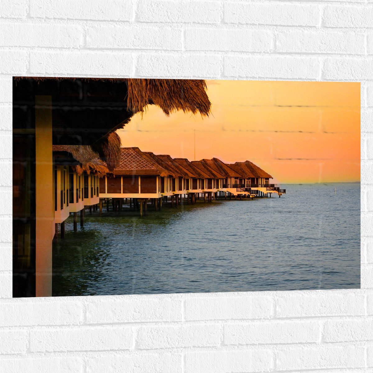 Muursticker - Huisjes op Palen in de Zee - 90x60 cm Foto op Muursticker