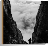 WallClassics - Hout - Man tussen Rotsen boven Wolken in Zwart-wit - 50x50 cm - 12 mm dik - Foto op Hout (Met Ophangsysteem)