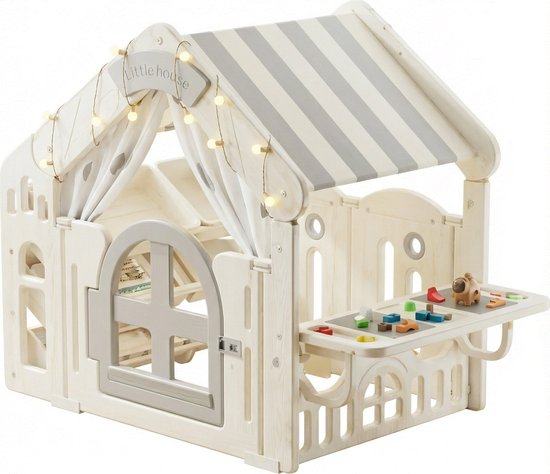 Maisonnette blanche à toit rayé gris, avec des jouets sur la table.
