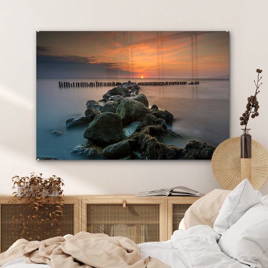 MuchoWow® Glasschilderij 120x80 cm - Schilderij acrylglas - Zee - Zon - Stenen - Foto op glas - Muurdecoratie woonkamer - Wanddecoratie slaapkamer - Schilderijen
