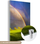 MuchoWow® Glasschilderij 80x120 cm - Schilderij acrylglas - Dubbele regenboog boven een groen landschap - Foto op glas - Schilderijen