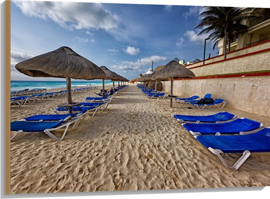 WallClassics - Hout - Blauwe Ligbedden op Strand met Rieten Parasols - 100x75 cm - 9 mm dik - Foto op Hout (Met Ophangsysteem)