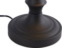 Détail de la base ronde noire d'une lampe de banquier avec un cordon.