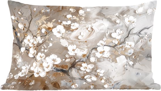 Coussin beige clair avec des branches de fleurs blanches et dorées dans un style pictural.