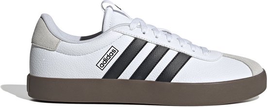Witte sneaker met zwarte Adidas strepen en bruine zool, op witte achtergrond.