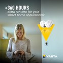 Vrouw met smartphone en koptelefoon, Varta CR2032 batterijen met +360 uur looptijd voor smart home.