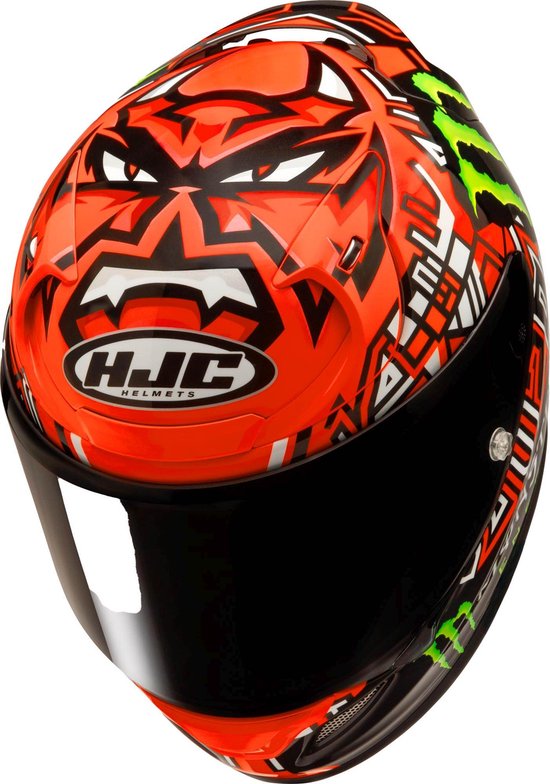 HJC motorhelm met zwart vizier, oranje voorzijde met demonengezicht en Monster Energy logo's.