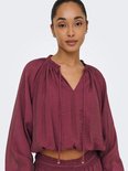 Bordeauxrode crop top met rucheskraag, strikdetail en ballonmouwen, gedetailleerd.