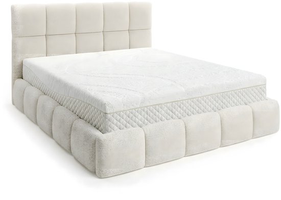 Wit matras met een gewatteerd, blokvormig bedframe en hoofdbord in teddy stof.