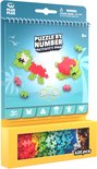 Plus-Plus Activity Pad: Oceaan designs met groene en rode schildpad. Onderin een gele kist met 125 gekleurde bouwblokjes.