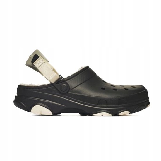 Crocs noirs à semelle épaisse, sangle beige et doublure crème. Détails blancs sur la semelle.