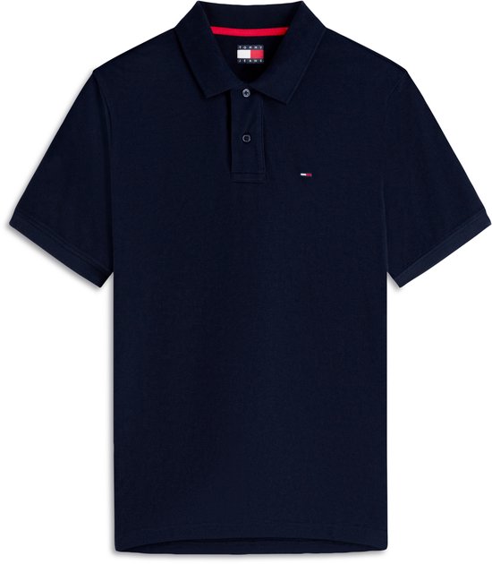 Donkerblauwe polo met korte mouwen, knoopsluiting en klein vlaglogo op de borst.