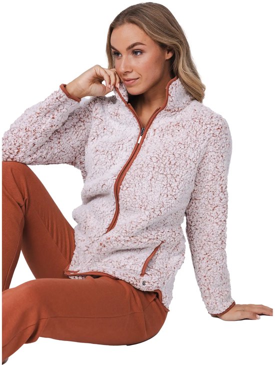 Vrouw in een lichtroze teddy fleece trui met bruine rits en broek.