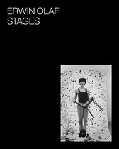 Jonge man in tanktop en broek, houdt een stoel vast voor een doek met abstracte patronen. ERWIN OLAF STAGES.