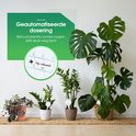 Geautomatiseerde waterdosering voor planten, zelfs tijdens vakantie. Een ronde kalender met vakantie-aanduiding is zichtbaar.