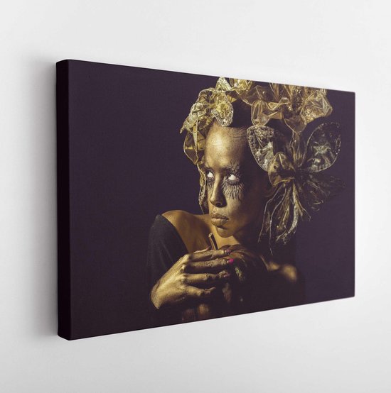 Halloween golden woman or girl holding painted gold pumpkin has pretty face with makeup and body art metallized color with decorative flowers on head on black background. - Modern Art Canvas - Horizontal - 1165611829 - 50*40 Horizontal