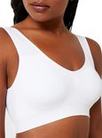 Witte comfort beha met v-hals en brede bandjes, gedragen door een donkere vrouw.
