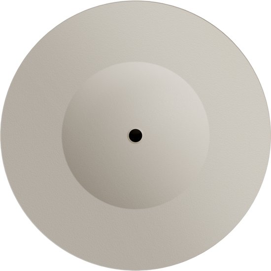 Bovenaanzicht van een ronde, beige diffuser met een licht gebogen oppervlak en een centraal zwart punt.