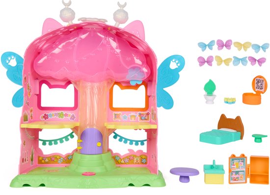 Roze Fairylandia speelhuis met accessoires, waaronder een bed, tafel en koelkast.