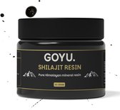 Een zwarte pot met GOYU Shilajit Resin, 50 gram. Omringd door druppels en spatten.