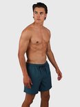 Homme portant un maillot de bain vert Fuel. Le maillot de bain a un cordon de serrage et un logo sur la jambe gauche.