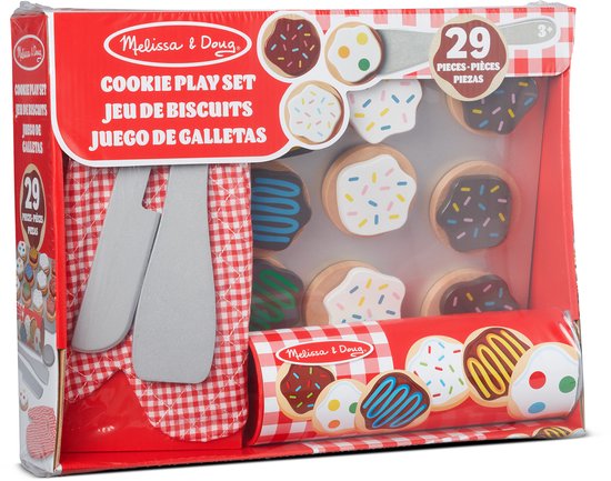De verpakking van een 'Melissa & Doug Cookie Play Set'. De doos bevat houten koekjes, een bakplaat, ovenwant, spatel en mes.