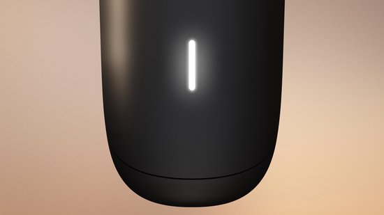 Close-up van het onderste deel van een zwarte Philips trimmer met een wit indicatielampje.