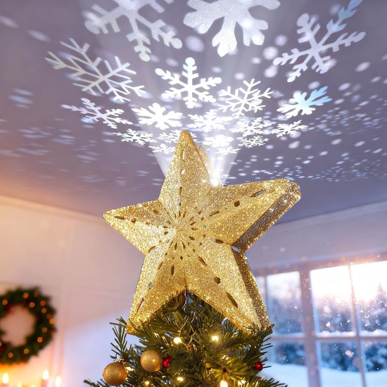 Gouden, sprankelende kerstboomster met gesneden patroon en projectie van sneeuwvlokken.