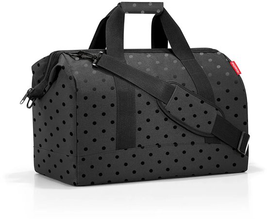 Zwarte weekendtas met handvatten, schouderband en een subtiel stippenpatroon.