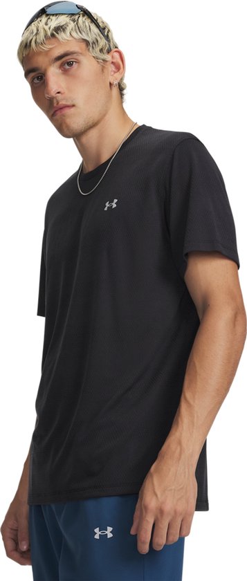 Man met zonnebril op hoofd, draagt zwart sportshirt met UA logo.