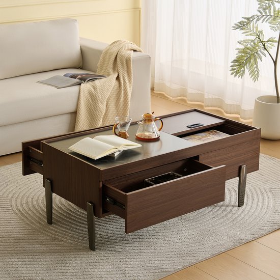 Table basse design bois marron foncé avec plateau aspect marbre, deux tiroirs ouverts, une théière et un verre.