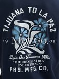 Donkerblauw T-shirt met grafische print van bloemen en tekst "Tijuana To La Paz", "Baja One Thousand Mx.", "The Roughest Run Under The Sun", "P89. MFG. CO."