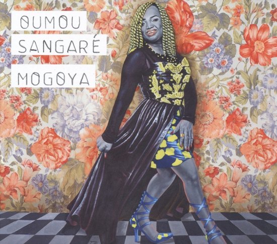 Albumhoes met Oumou Sangaré op een bloemenbehang, met gele en blauwe kleding en hoge hakken.