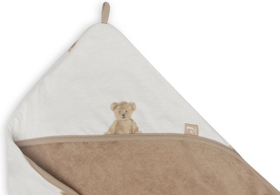 Gros plan sur la pointe d'une cape de bain blanc cassé avec imprimé ours en peluche et bordure beige. Le logo Jollein est visible.