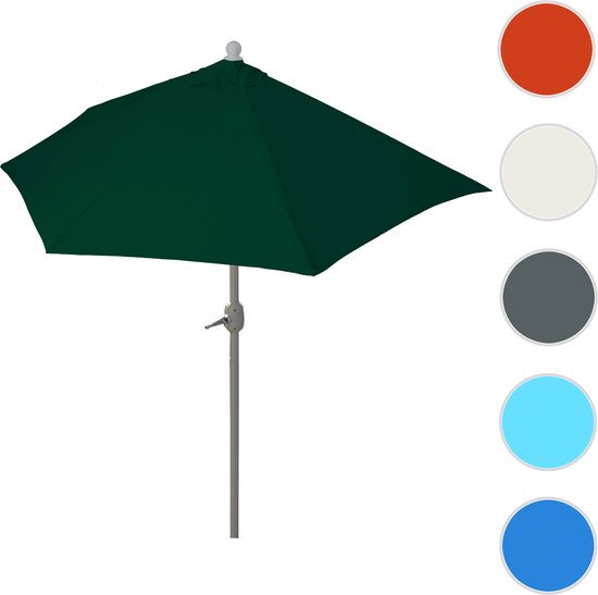 Donkergroene parasol met grijze paal, met cirkels van andere kleuren ernaast.