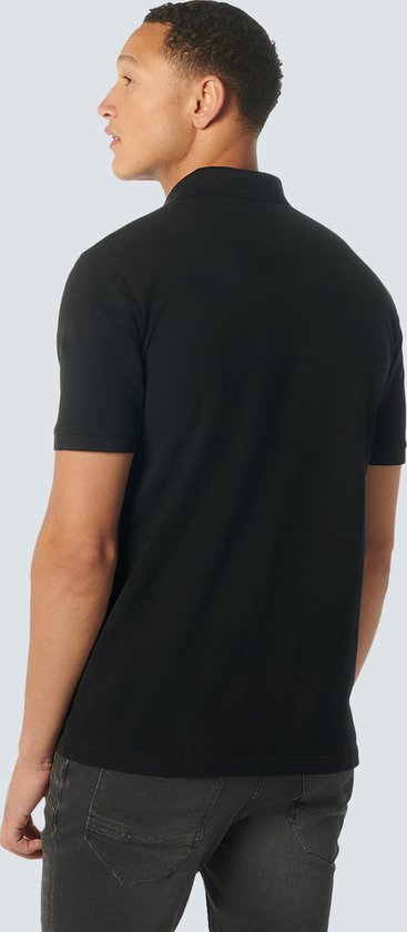 Achterkant van een man in een zwart poloshirt.