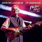 John McLaughlin & The 4th Dimension, Montreux Jazz Festival 2022. McLaughlin tenant une guitare, gilet violet, chemise beige clair.