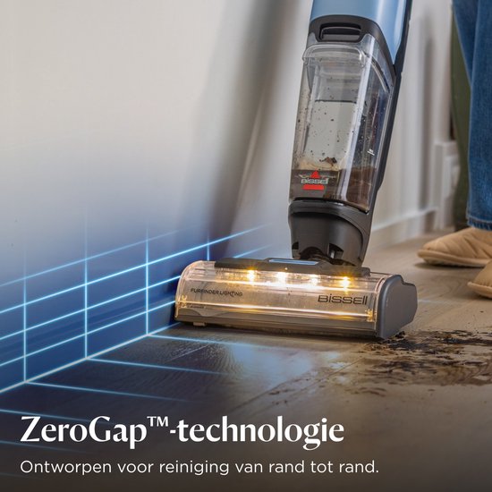 Een stofzuiger met ledverlichting bij de borstelkop die vuil langs de plint opzuigt. ZeroGap technologie.