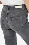 Close-up van de achterkant van een grijze, uitlopende jeans, met label